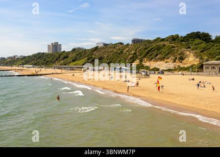 Boscombe, Bournemouth, Dorset, Inghilterra, Regno Unito, venerdì 4 luglio 2025, Meteo: persone sulla spiaggia con caldo sole estivo pomeridiano sulla costa meridionale prima di cambiare il clima piovoso durante il fine settimana. Foto Stock