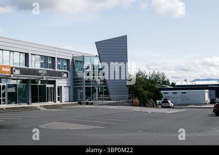 Reykjavik, Islanda - 28 giugno 2025: Architettura contemporanea che ospita negozi e uffici situati a Skeifan, Reykjavik, Islanda, sotto cieli limpidi Foto Stock