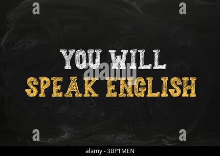 Parlerai un'iscrizione in inglese sulla lavagna nera. Corso di lingua Foto Stock