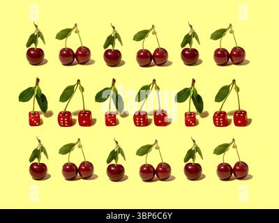 Motivo a base di ciliegie frutta e dadi da gioco rossi. Foto Stock