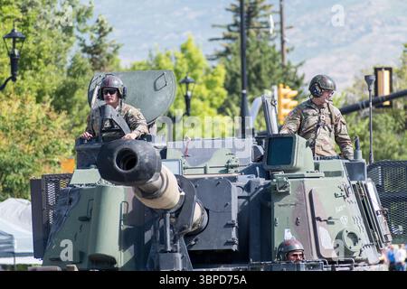 Provo, UT – 4 luglio 2025: Il personale dell'esercito AMERICANO sale sulla cima di un veicolo militare durante la Freedom Festival Grand Parade, onorando il servizio il giorno dell'indipendenza Foto Stock