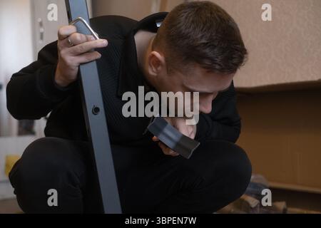 Lo specialista nella riparazione e assemblaggio di mobili aggiorna i mobili a casa senza bisogno di rimozione o di ulteriori problemi. Foto Stock