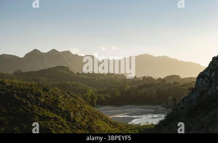 Splendida insenatura circondata da foreste e montagne sulla costa asturiana Foto Stock