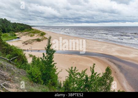 Vista della Duna Bianca a Saulkrasti, Lettonia, sulla costa del golfo di Vidzeme, sul Mar Baltico con il mare aspro e il cielo nuvoloso sullo sfondo Foto Stock