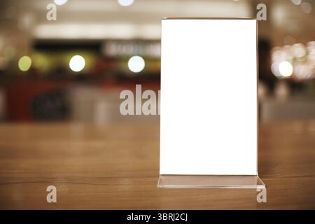 Telaio di menu in piedi sulla tavola di legno nel bar ristorante cafe. spazio per il testo marketing promozione Foto Stock