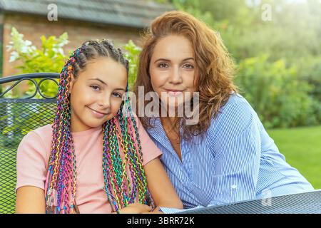 Ritratto di madre e figlia sorridenti alla telecamera. Orizzontalmente. Foto Stock