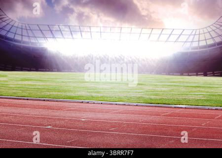 Design piatto che mostra una pista da corsa rossa vuota intorno al campo di erba verde sotto la tettoia in vetro illuminata Foto Stock
