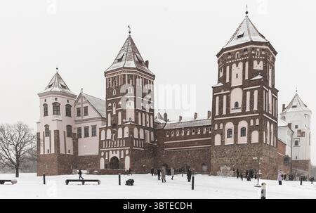 Mir, Bielorussia - 4 gennaio 2024: Complesso del castello di Mir in una giornata invernale, i turisti sono di fronte all'ingresso principale. Si tratta di uno storico castello fortificato Foto Stock