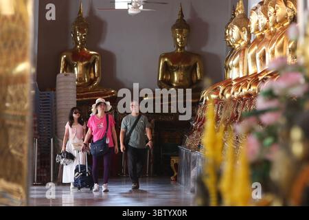 Bangkok, Thailandia. 15 luglio 2025. I turisti vestiti con costumi thailandesi visitano il tempio Wat Pho a Bangkok, Thailandia, 15 luglio 2025. Il tempio Wat Pho è uno dei più magnifici complessi di templi buddisti di Bangkok. Crediti: Rachen Sageamsak/Xinhua/Alamy Live News Foto Stock