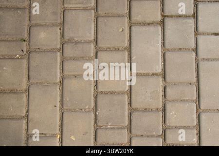 Immagine di sfondo rettangolare in pietra, lastre di pavimentazione sulla strada, struttura di pavimentazione, pietra grigia, superficie stradale Foto Stock