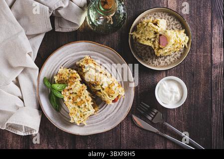 Cibo, salsicce avvolte in pancake di cavolo tagliati su un piatto con vista dall'alto Foto Stock