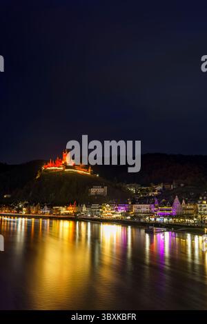 La pittoresca cittadina di Cochem, in Germania, brilla di notte nel cuore della valle della Mosella. Cochem offre una magica miscela di fascino medievale, vigneti Foto Stock