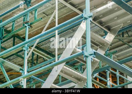 Vista dettagliata dell'impalcatura in acciaio con travi rinforzate e scale integrate su un cantiere edile alto Foto Stock