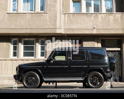 Bucarest, Romania – 20 luglio 2025: Vista laterale del SUV Mercedes-Benz G400d G-Wagon 4x4 nero parcheggiato in strada di fronte a casa in città Foto Stock