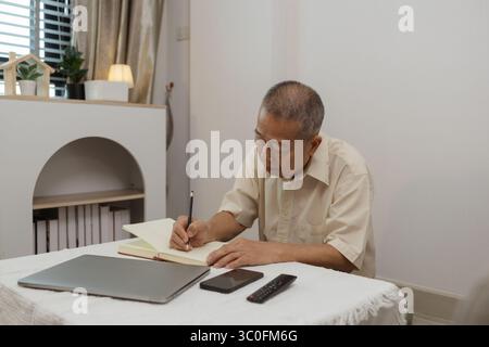 un padre trascorre i suoi anni di pensione comodamente nella sua casa, un nonno trascorre il suo tempo libero durante il giorno facendo varie attività nei vivi Foto Stock