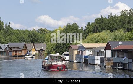 Casa galleggiante, case per le vacanze sul canale tra Mirower SEE e Zotzensee, Mirow, distretto dei laghi di Meclemburgo, Meclemburgo-Vorpommern, Germania Foto Stock