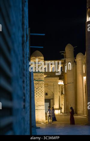 Khiva, Uzbekistan - 12 luglio 2024: Foto notturna di un vicolo illuminato nella storica città di Khiva, Uzbekistan, con luci calde e tradizionali Foto Stock