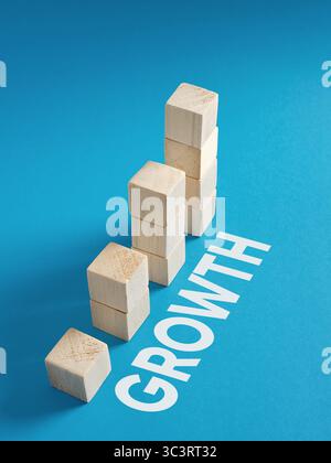 Blocchi di legno che formano un grafico crescente accanto alla parola "crescita", illustrando il concetto di sviluppo personale e aziendale. Foto Stock