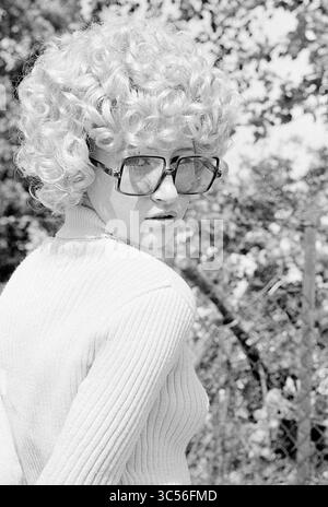 Models Loe-Loe, Models, 29-05-1971 Whizgle News, Dutch Desk, Paesi Bassi, 1950-2000 Una persona con capelli voluminosi e ricci e occhiali oversize torna ad affrontare lo spettatore, vestito con un maglione aderente sullo sfondo del verde. Foto Stock