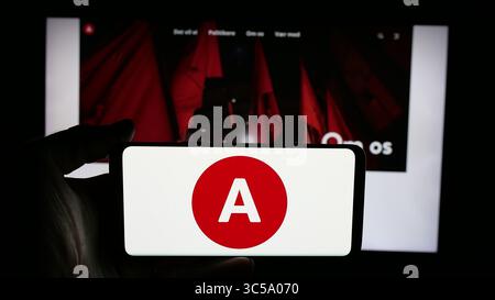 In questa foto, una persona tiene in mano un cellulare con il logo del partito politico danese Socialdemokraterne (S) sullo schermo davanti alla pagina web. Foto Stock