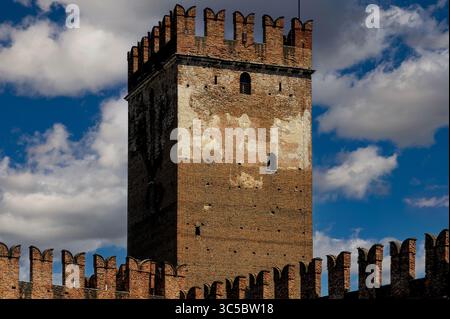 Formidabile fortezza della metà degli anni '1300 proteggeva il dispotico della Scala o signori Scaligeri di Verona, Veneto, Italia, dalle città-stato rivali e dai loro stessi cittadini. Castelvecchio, lungo il fiume Adige, fondata nel 1354 da Cangrande II della Scala, noto come «CAN Rabbioso». Difeso da fossati profondi, ponti levatoi, fortissime mura in mattoni e merlature a coda di rondine. Foto Stock