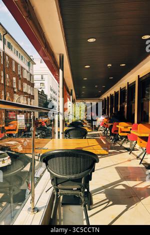 Vista dell'area pranzo di un ristorante con vista sui veicoli e le aziende in Standard Street nel centro di Nairobi City, Kenya Foto Stock