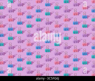 Modello di cancelleria con clip colorate su sfondo lilla chiaro Foto Stock