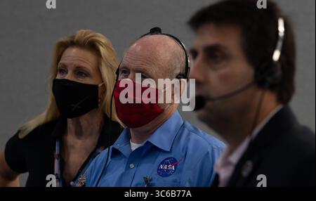 31 maggio 2020, Cape Canaveral, FL, Stati Uniti d'America: Janet Karika, capo di stato maggiore della NASA, Left, Ken Bowersox, amministratore associato facente funzione per la missione di esplorazione umana e operazioni, e Joel Montalbano, vice Program Manager della stazione spaziale Internazionale, guarda come la navicella spaziale SpaceX Crew Dragon ormeggia con la stazione spaziale Internazionale dal controllo della missione al Kennedy Space Center 31 maggio 2020 Cape Canaveral, in Florida. La navicella spaziale trasportò con successo gli astronauti Douglas Hurley e Robert Behnken alla stazione spaziale Internazionale. (Immagine di credito: © Joel Foto Stock