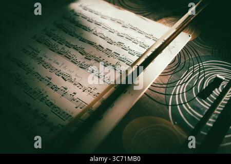 Fiocco e fogli per violoncello, composizione sarabande di Bach, interessante luce laterale. Foto Stock