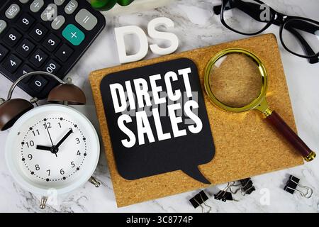DS Direct Sales text con calcolatrice, sveglia e lente d'ingrandimento su sfondo in marmo Foto Stock