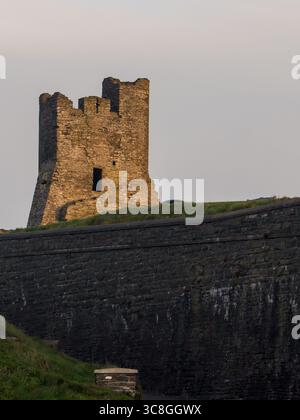 La torre rotta di ciò che rimane del castello di Aberystwyth in Galles, nella luce dorata del mattino presto, Foto Stock