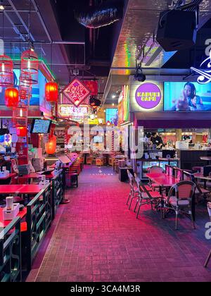 Bar giapponese con luce calda e tavoli vuoti, invitando gli ospiti a rilassarsi in una tranquilla atmosfera notturna. Foto Stock