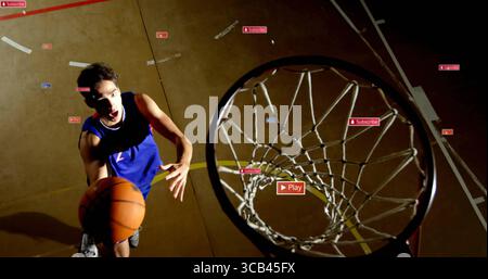 Giocatore di pallacanestro che salta in maglia blu, palla da ginnastica, con icone sovrapposte e spazio per copiare Foto Stock