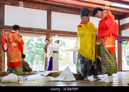 Un gruppo di individui vestiti con colorato abbigliamento tradizionale giapponese prima dell'inizio del festival Kamo Kurabeuma al santuario Kamigamo Foto Stock