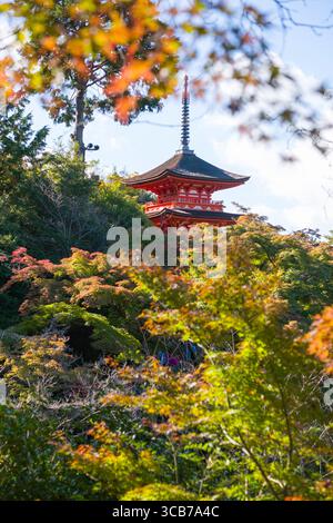 Il fogliame autunnale incornicia una pagoda rossa di Kiyomizu-dera Koyasunoto tra un bosco sereno, che evoca tranquillità e armonia, Kyoto, Giappone Foto Stock