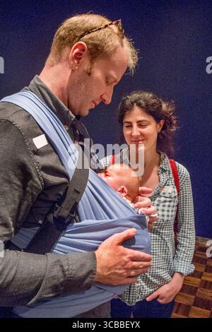 7 ottobre 2016: Il padre di una neonata porta sua figlia in una fionda mentre sua madre guarda affettuosamente a New York. (Immagine di credito: © Spencer Grant/ZUMA Press Wire) Foto Stock