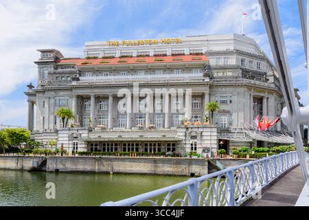 Il Fullerton Hotel è incorniciato dal Cavenagh Bridge e dal fiume Singapore, Fullerton Square, Singapore Foto Stock