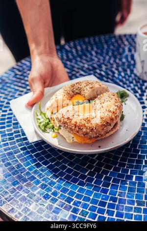Bagel Sandwich appena preparato servito su piatto bianco Foto Stock