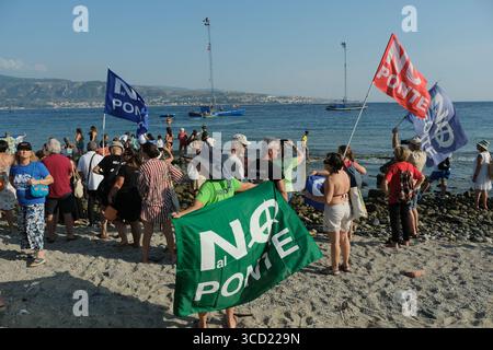 I dimostranti accolgono con favore l'arrivo delle tradizionali barche da pesca conosciute come feluche, navigando con le bandiere "No Ponte". La protesta fa parte del movimento che si oppone alla costruzione del ponte sullo stretto di Messina. Foto Stock