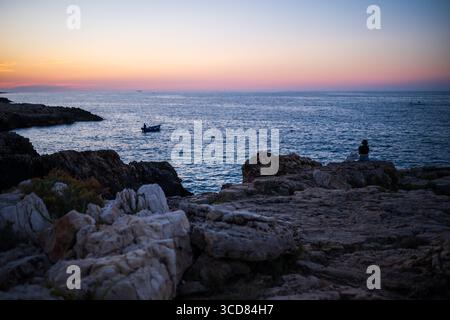 Barca da pesca al tramonto a Polignano a Mare, Puglia, Italia Foto Stock