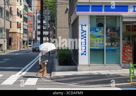 TOKYO, GIAPPONE - 29 giugno 2025: Strada con un minimarket Lawson nel centro di Tokyo in estate. Foto Stock