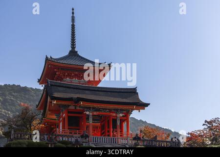Pagoda Sanjunoto Rossa nel complesso del tempio Kiyomizu-dera, Higashiyama, Kyoto, Giappone, posta contro alberi di collina e cielo blu Foto Stock