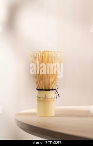 Frusta di bambù chasen artigianale, essenziale per preparare un matcha morbido e spumoso in autentiche cerimonie giapponesi del tè o momenti tranquilli del tè casalingo. Foto Stock