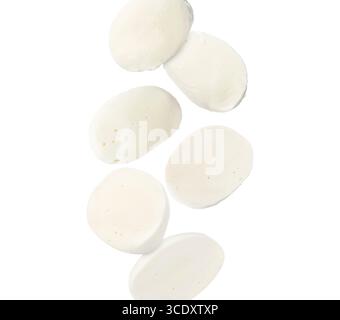 Pezzi di mozzarella che cadono su sfondo bianco Foto Stock