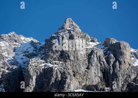Vetta rocciosa innevata nel Parco Nazionale Picos de Europa, Spagna, sotto il cielo azzurro. Foto Stock