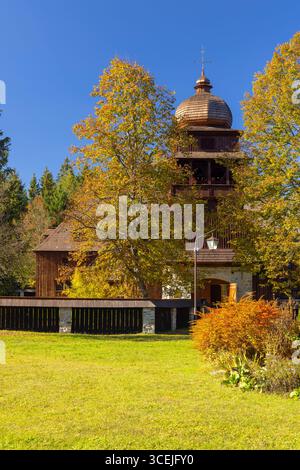 Chiesa articolare in legno di Svaty Kriz circondata da colorate foglie autunnali in Slovacchia Foto Stock