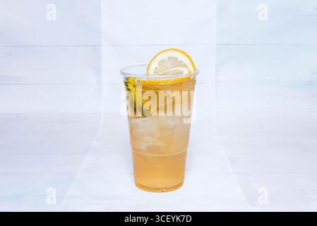 Sapore dell'infanzia: Limonata come quella della nonna, con spicchi di limone, zucchero di canna e ghiaccio in un bicchiere denso che trasuda freschezza Foto Stock