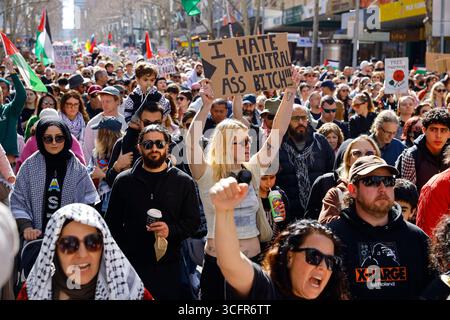 Melbourne, Australia. 24 agosto 2025. (NOTA DELL'EDITORE; l'immagine contiene profanità)Un manifestante tiene un cartello durante la manifestazione. Un raduno nazionale per la Palestina ha avuto luogo in tutta l'Australia, con marce tenute in 39 città e paesi, tra cui una grande manifestazione attraverso il CBD di Melbourne che ha attirato migliaia di manifestanti. Le proteste riflettono le continue preoccupazioni circa la posizione diplomatica dell'Australia nei confronti di Israele e Palestina, con molti che chiedono un sostegno più forte all'autodeterminazione palestinese e la fine dei legami militari con Israele. Credito: SOPA Images Limited/Alamy Live News Foto Stock