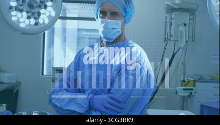 Chirurgo in piedi con indosso un abito blu, maschera sotto le luci nella suite chirurgica, con sovrapposizione cartografica a barre Foto Stock