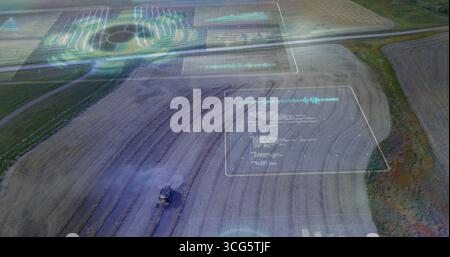 Mietitrebbia da raccolta in movimento su campi rurali con pennacchio di polvere, pannelli AR, spazio di copia Foto Stock